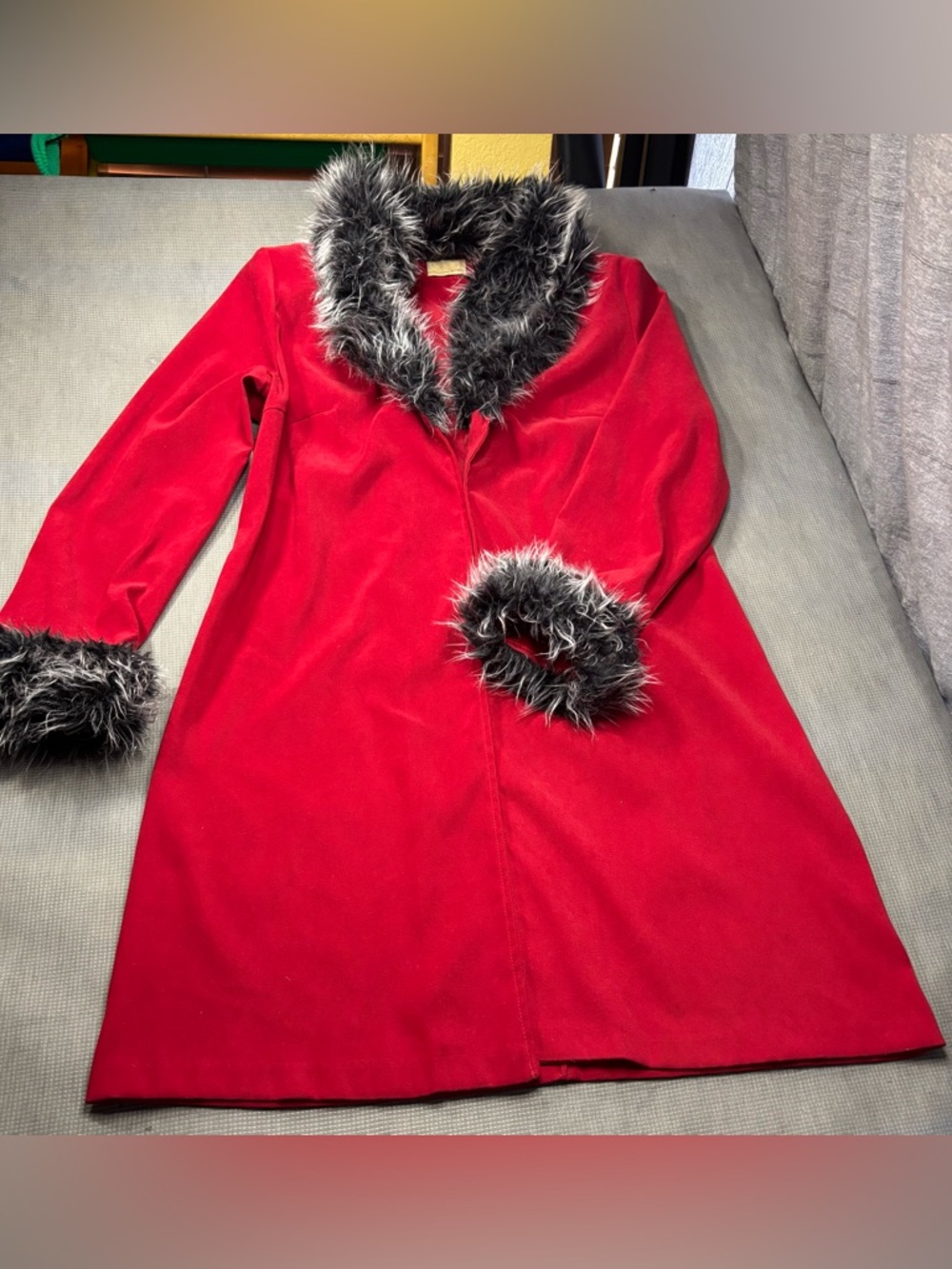 Red smooth-fabric coat with faux fur trim, it has no size-only measurements